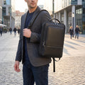 Close up view of the durable laptop backpack showing its high quality Pu leather fabric and precise stitching — view 3