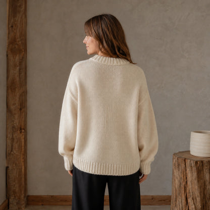 Woman wearing ivory white collegiate letter letterman sweater, complete back view — view 8