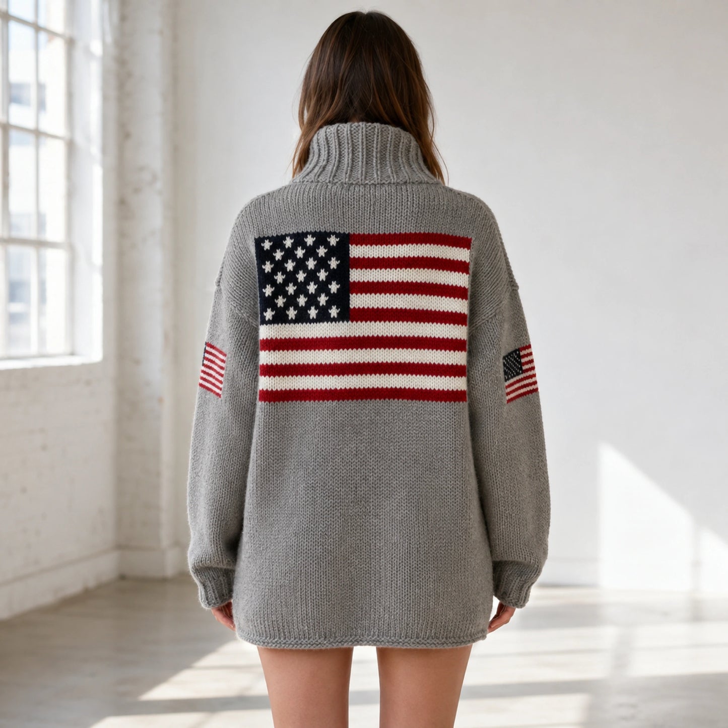 Female model wearing women's gray oversized flag knit letterman sweater, complete rear view — view 2
