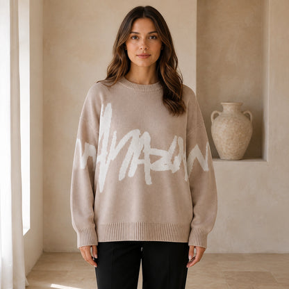 Woman wearing khaki graffiti jacquard letterman sweater, complete front view — view 5