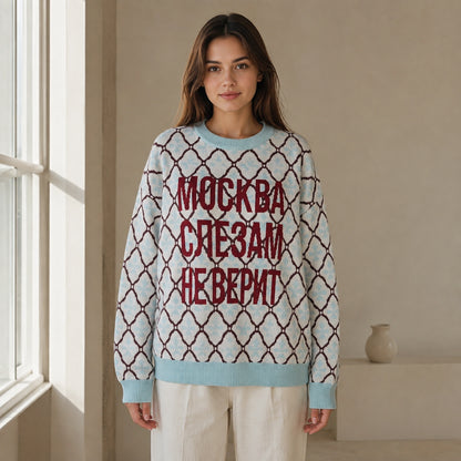 Woman wearing sky blue lattice jacquard letterman sweater, complete front view — view 4