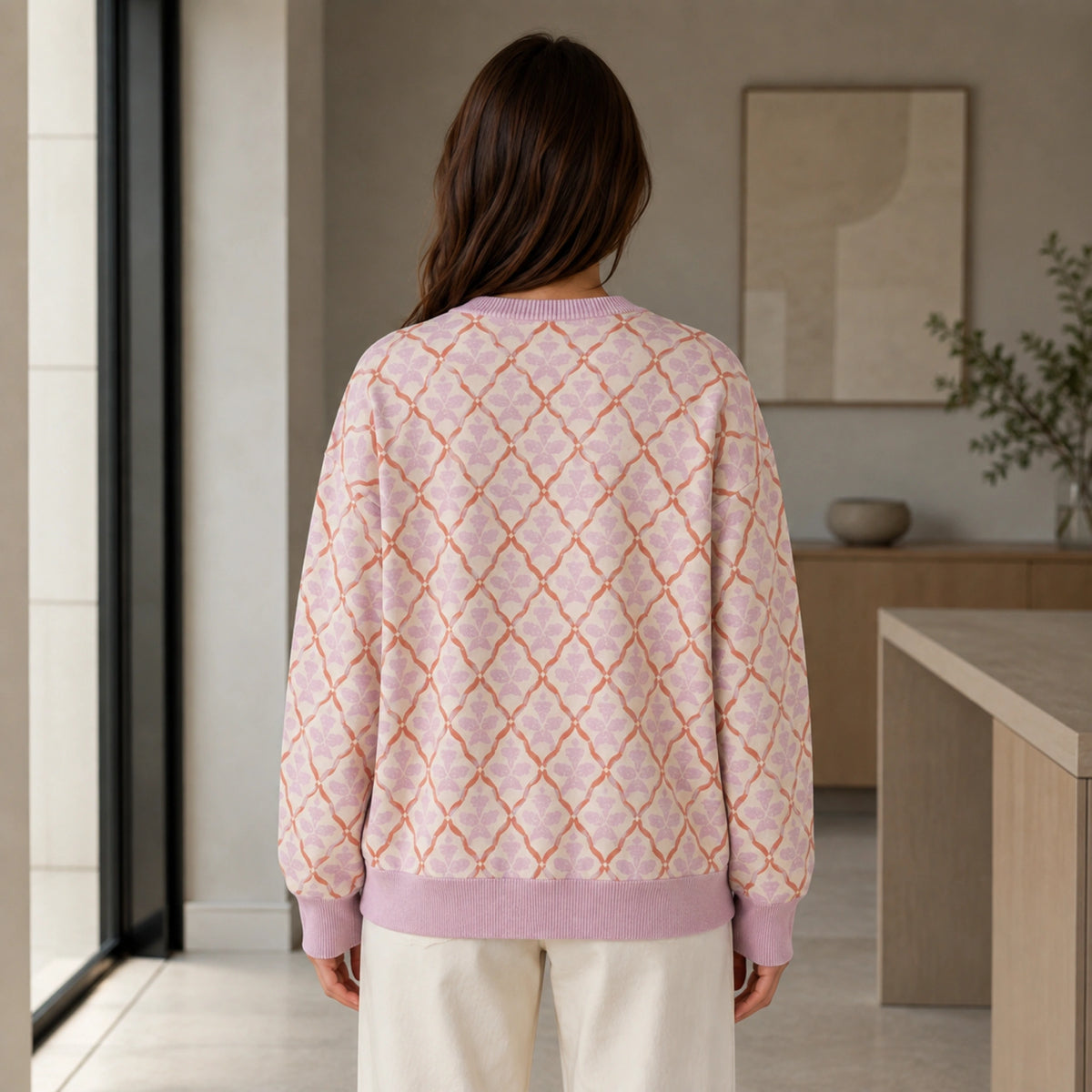 Woman wearing pink lattice jacquard letterman sweater, true back view — view 7