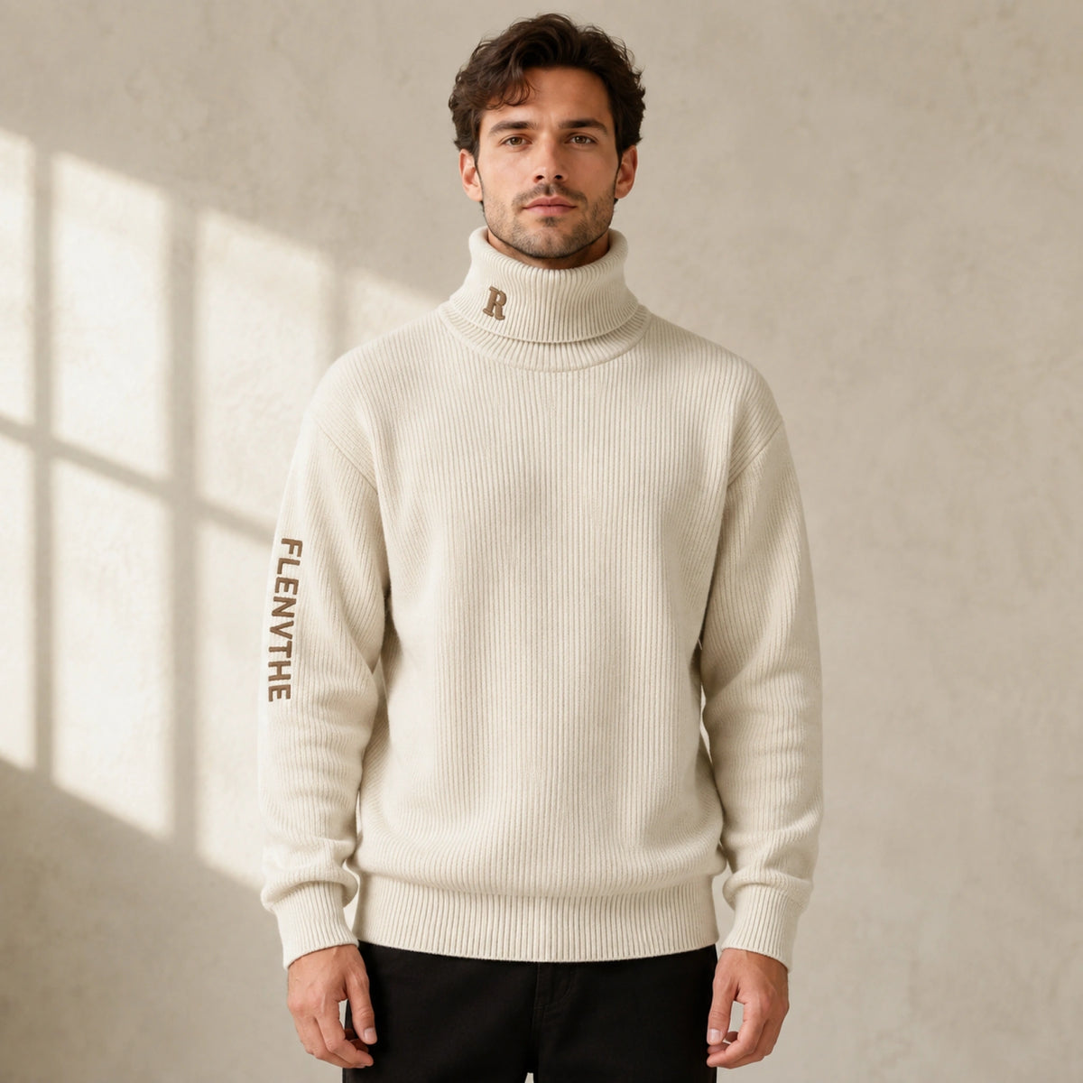 Male model wearing men's beige embroidered turtleneck letterman sweater, complete front view — view 2