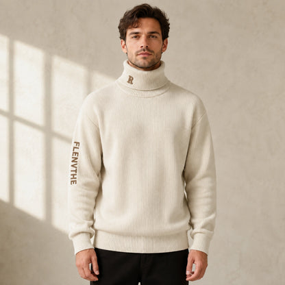 Male model wearing men's beige embroidered turtleneck letterman sweater, complete front view — view 2