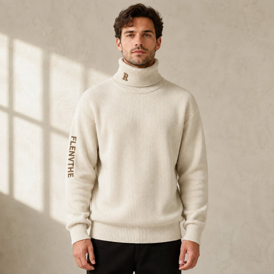Male model wearing men's beige embroidered turtleneck letterman sweater, complete front view — view 2