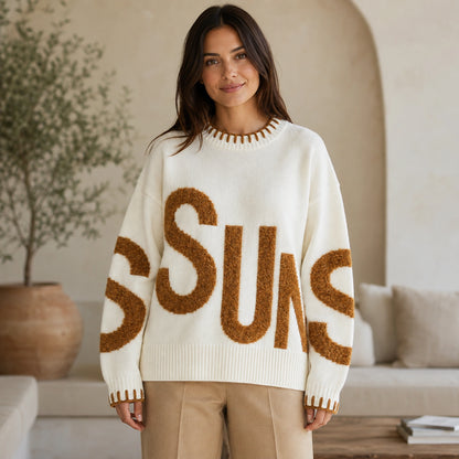 Woman wearing white fuzzy letter pattern letterman sweater, complete front view