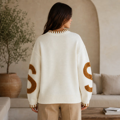 Woman wearing white fuzzy letter pattern letterman sweater, complete back view — view 7