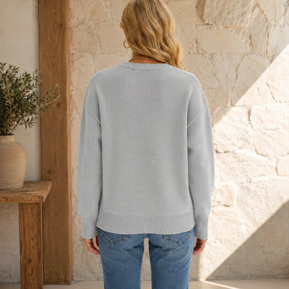 Female model wearing women's gray après ski jacquard letterman sweater, complete rear view — view 5