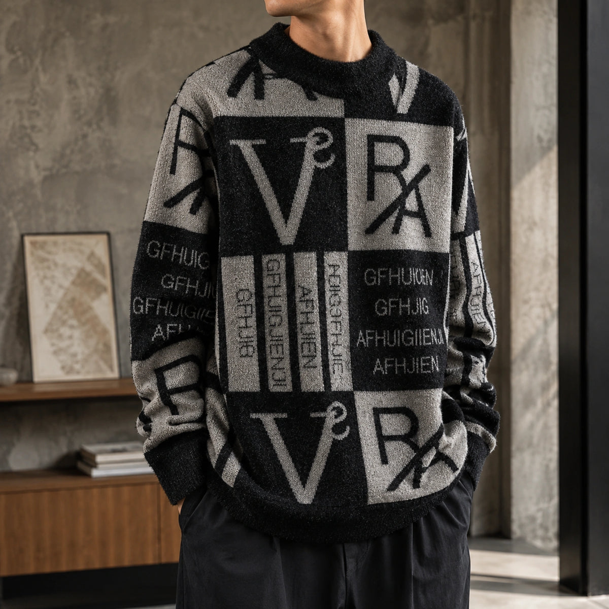 Male model wearing gray and black abstract jacquard letterman sweater, close up knit detail — view 6