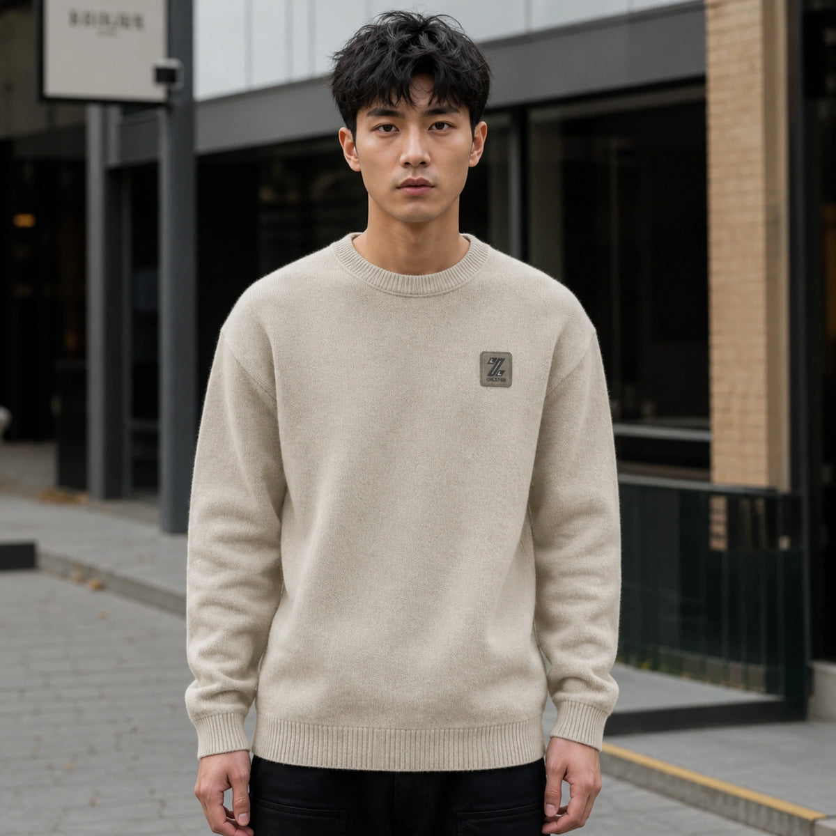 Male model wearing men's khaki fleece lined patch letterman sweater, complete front view