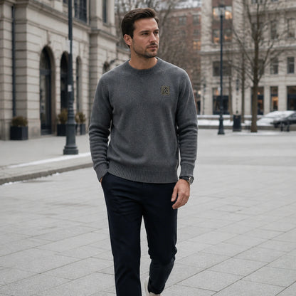 Male model wearing gray fleece lined patch letterman sweater outdoors in a winter city setting — view 7