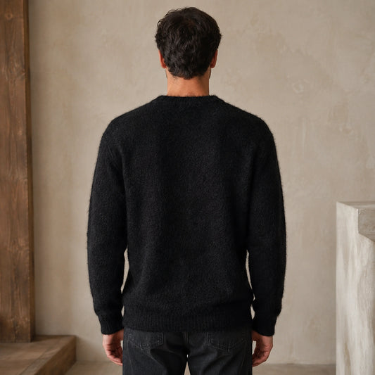 Male model wearing the black fuzzy letterman sweater in a natural back view — view 2