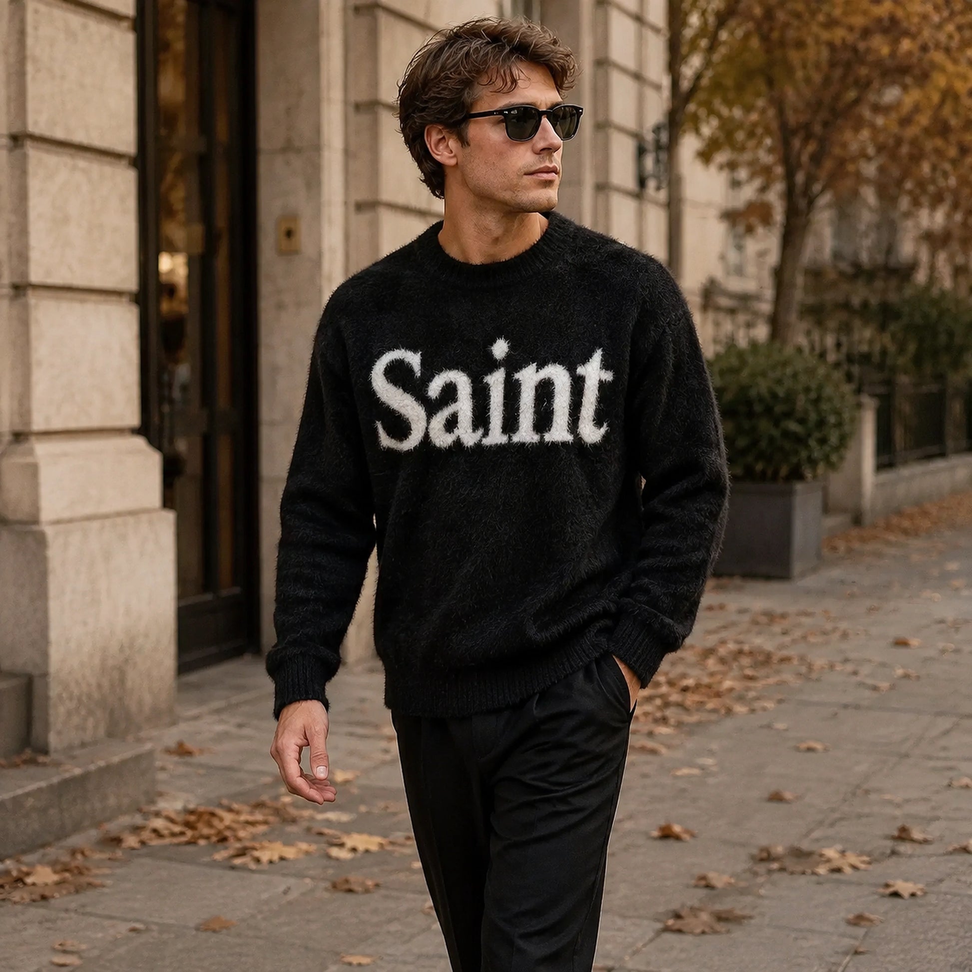 Male model wearing the black fuzzy Saint letterman sweater in an autumn city setting — view 5