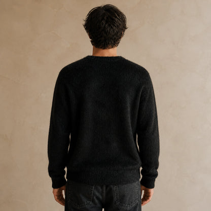 Male model wearing men's black fuzzy script letterman sweater, complete rear view — view 2
