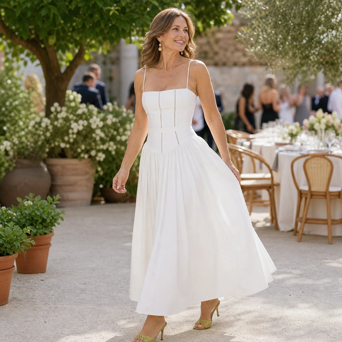 long wedding guest dress — Woman wearing white corset midi dress at a garden reception — view 12