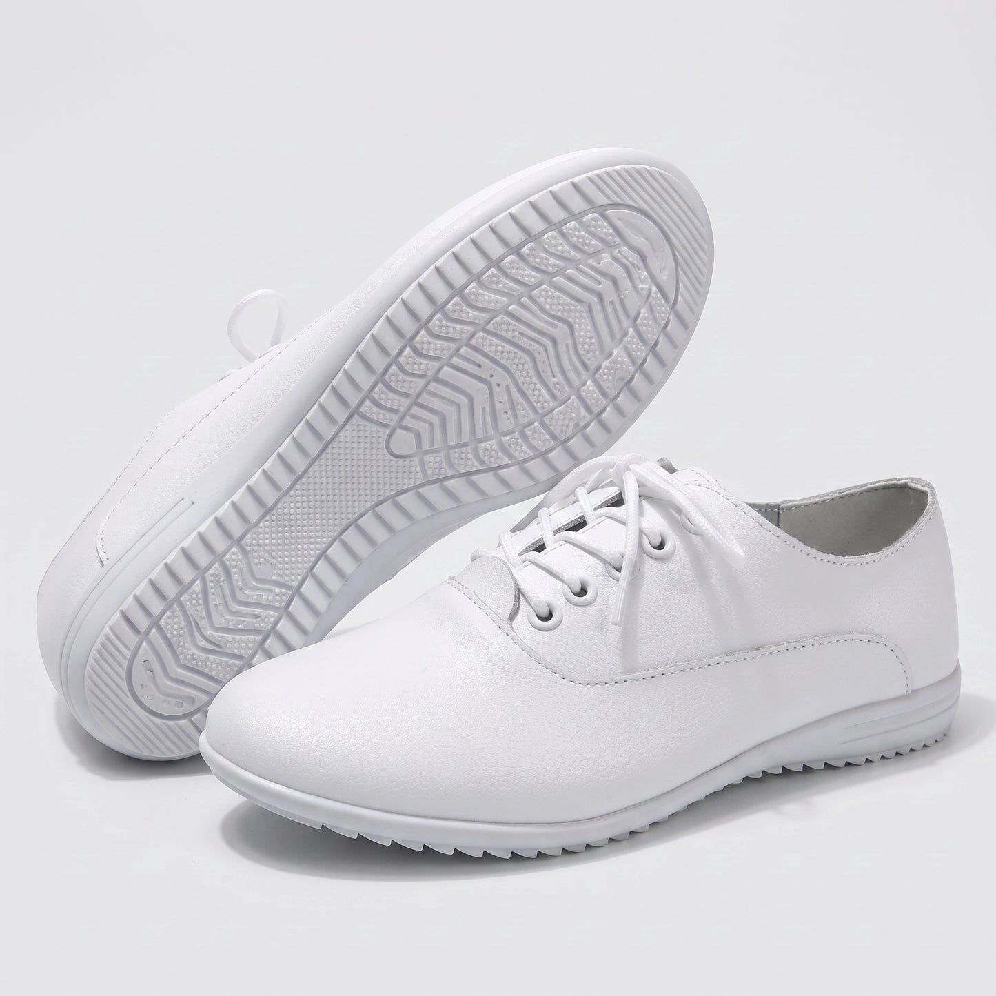 Close up view showing the soft split leather fabric and precise stitching details of comfortable marching band shoes in a