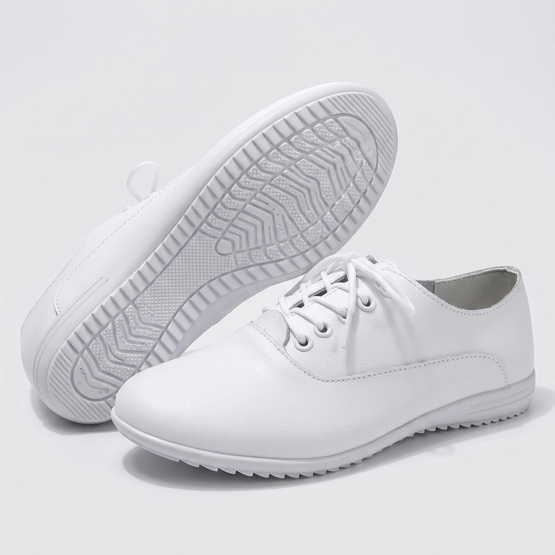 Close up view showing the soft split leather fabric and precise stitching details of comfortable marching band shoes in a