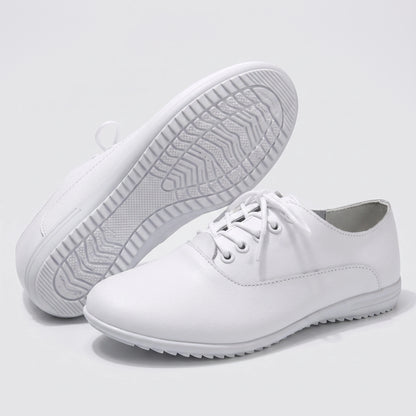 Close up view showing the soft split leather fabric and precise stitching details of comfortable marching band shoes in a
