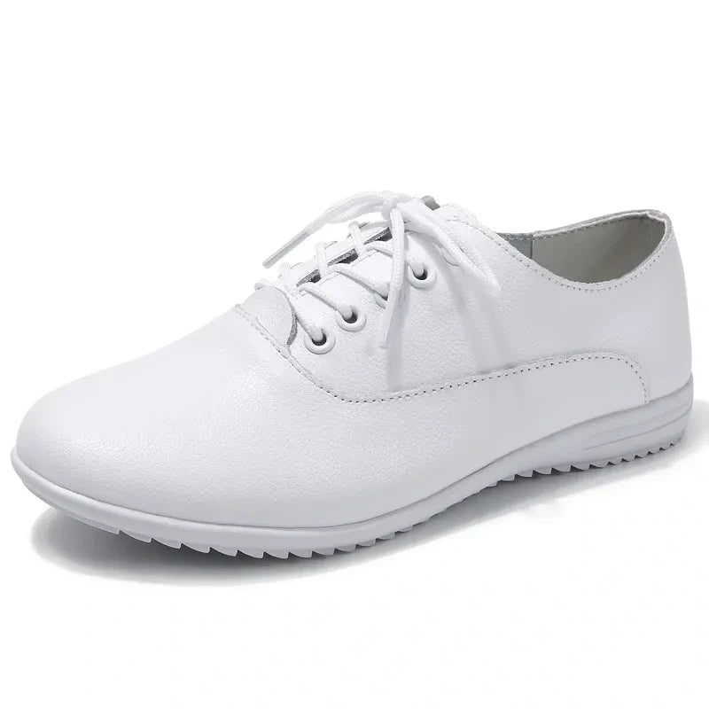 White marching band shoes with lace up design and textured sole, side view — view 2