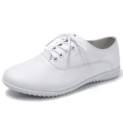 White marching band shoes with lace up design and textured sole, side view — view 2