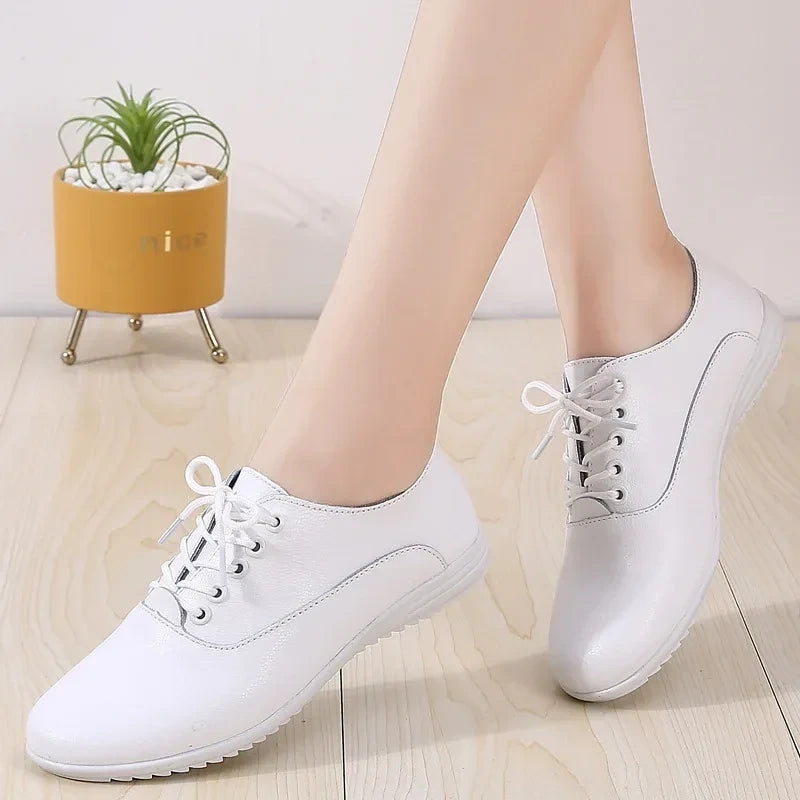 White marching band shoes with lace up design on a wooden floor — view 3 — view 3