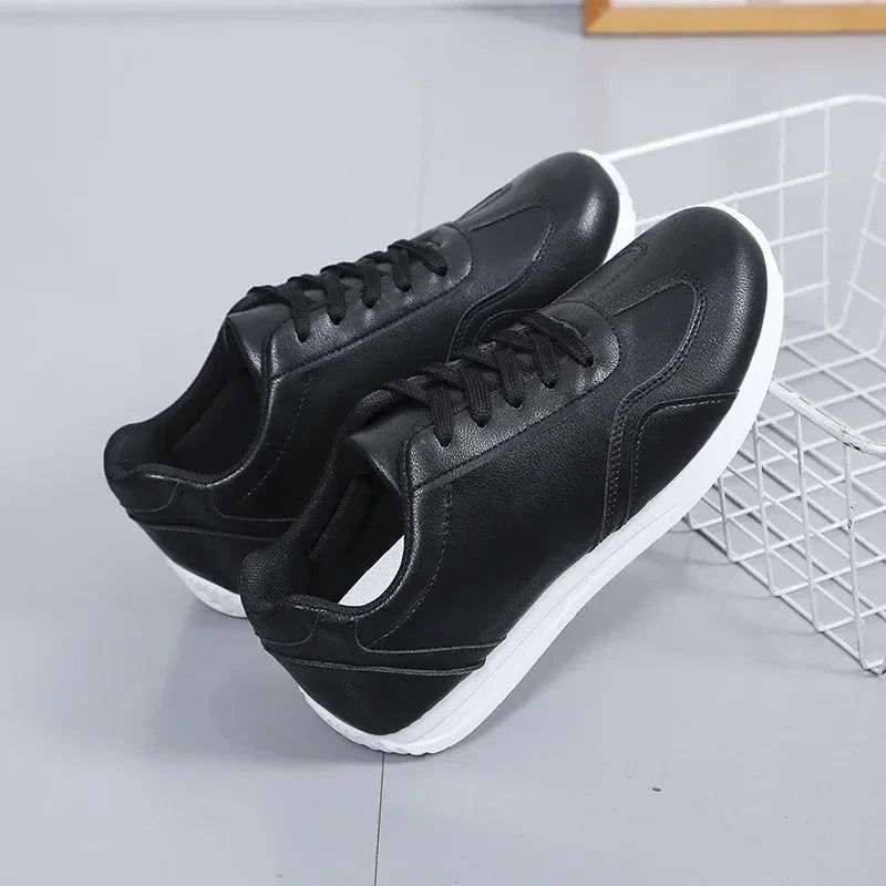 Black marching band shoes with white soles, featuring a lace up design on gray background — view 3 — view 3