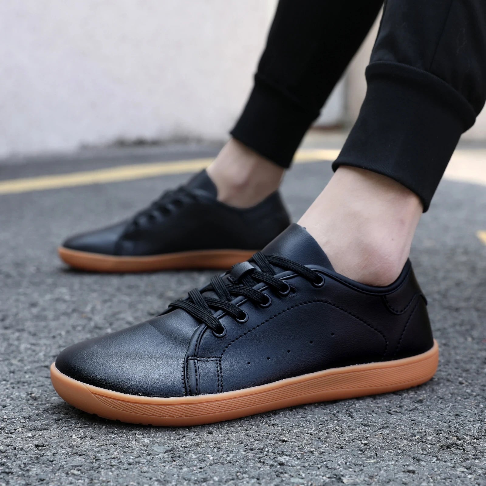 Black marching band shoes with wide toe and brown soles on pavement — view 15 — view 9