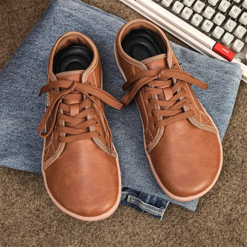 Comfortable brown marching band shoes with laces, placed on denim fabric — view 2