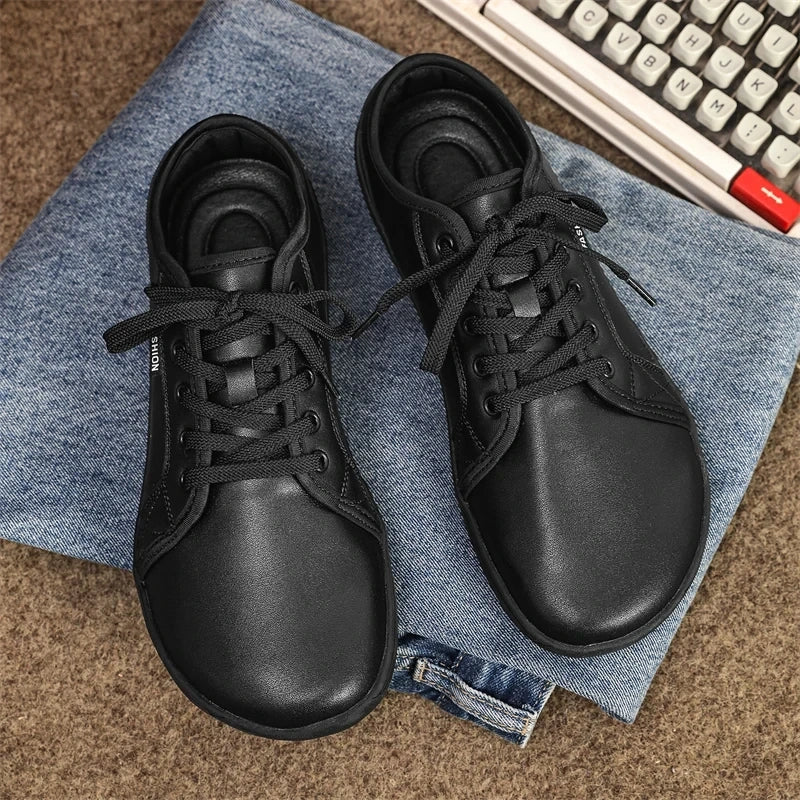 Black marching band shoes with laces, displayed on denim fabric — view 7 — view 4