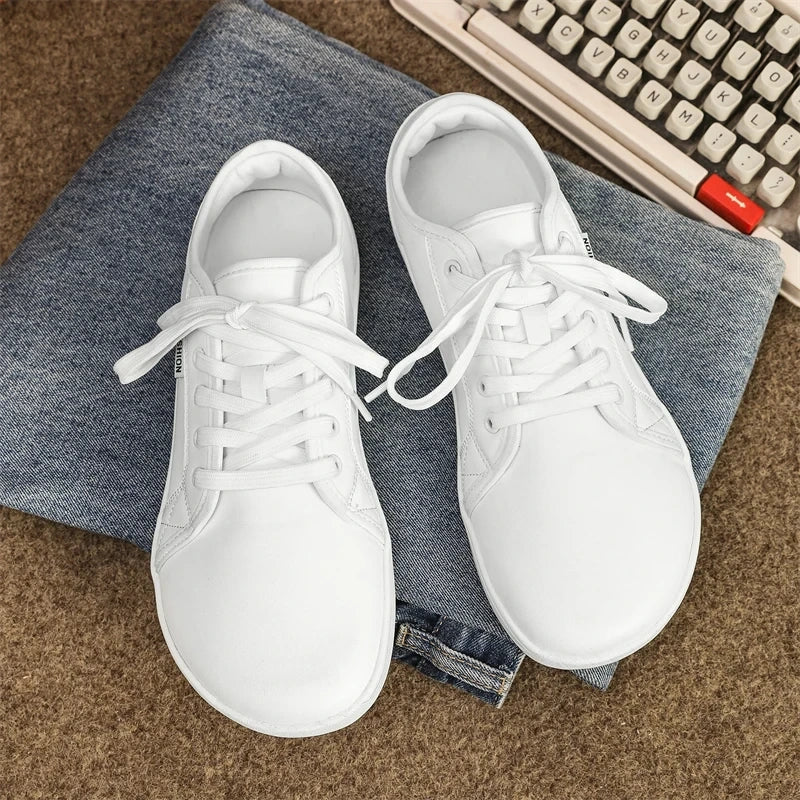 White marching band shoes with laces on a denim surface, top view — 8 — view 5