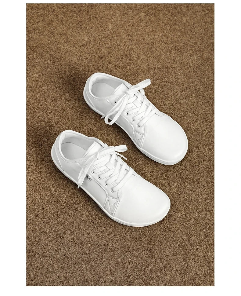White marching band shoes with laces on a brown carpet — view 18 — view 6