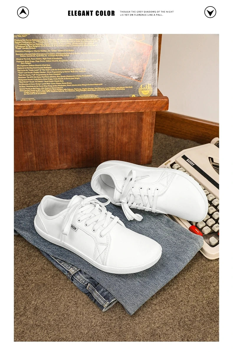 White marching band shoes with laces, displayed on folded jeans near a typewriter — view 26 — view 8
