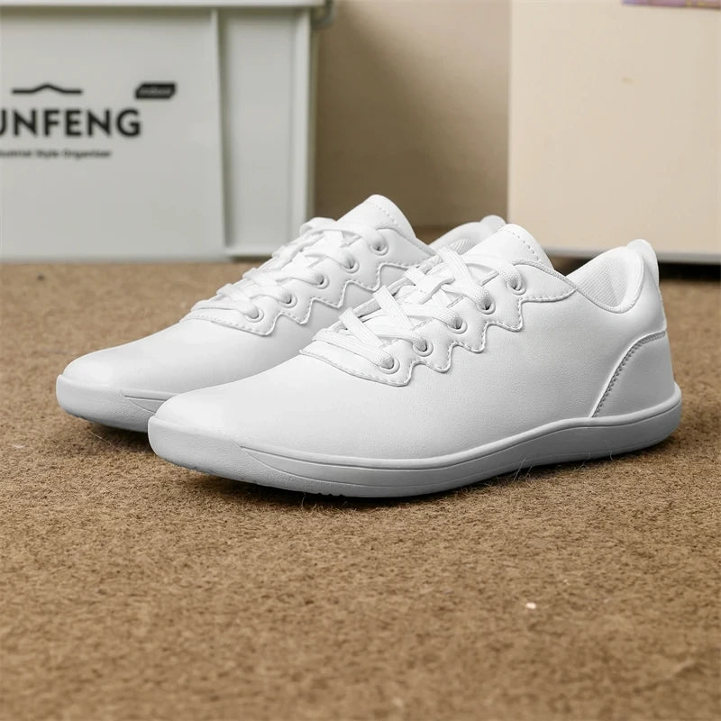 White marching band shoes with a wide fit and lace up design on carpeted floor — view 13 — view 11