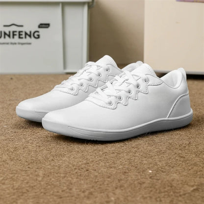 White marching band shoes with a wide fit and lace up design on carpeted floor — view 13 — view 11