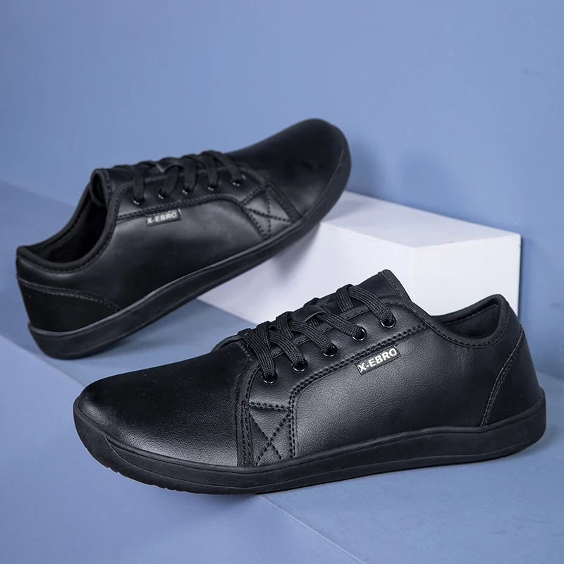 Black marching band shoes with wide toe design and lace up closure, displayed on a blue background — view 11 — view 6