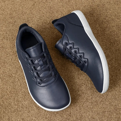 Dark blue marching band shoes with wide toe design and white sole on a textured surface — view 2 — view 3