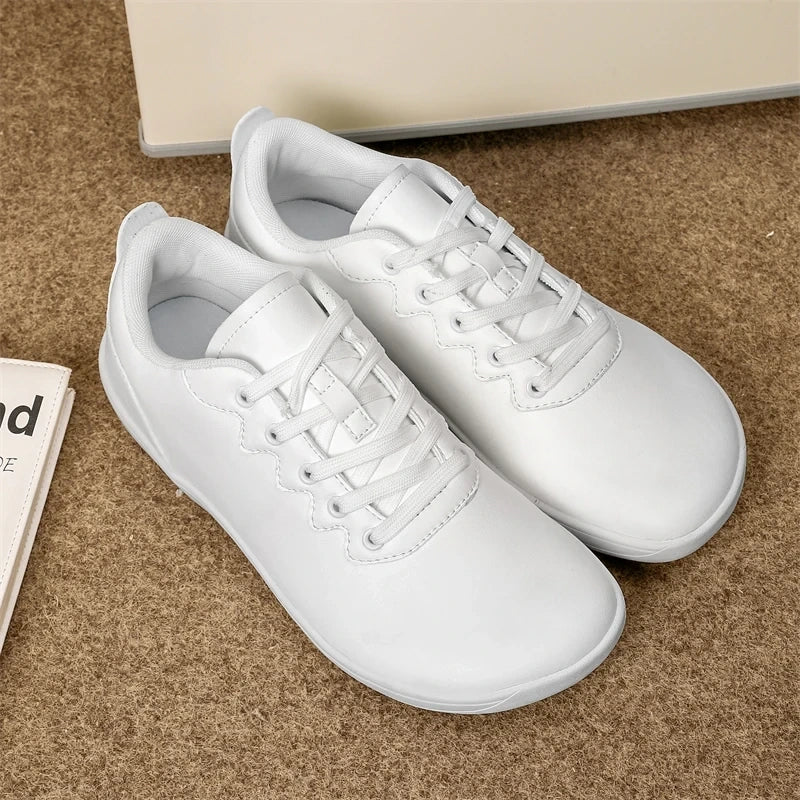 White breathable wide toe marching band shoes with laces on a carpeted surface — view 5 — view 6