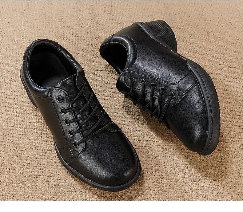 Black marching band shoes with lace up design and cushioned sole, angled view — 37 — view 10