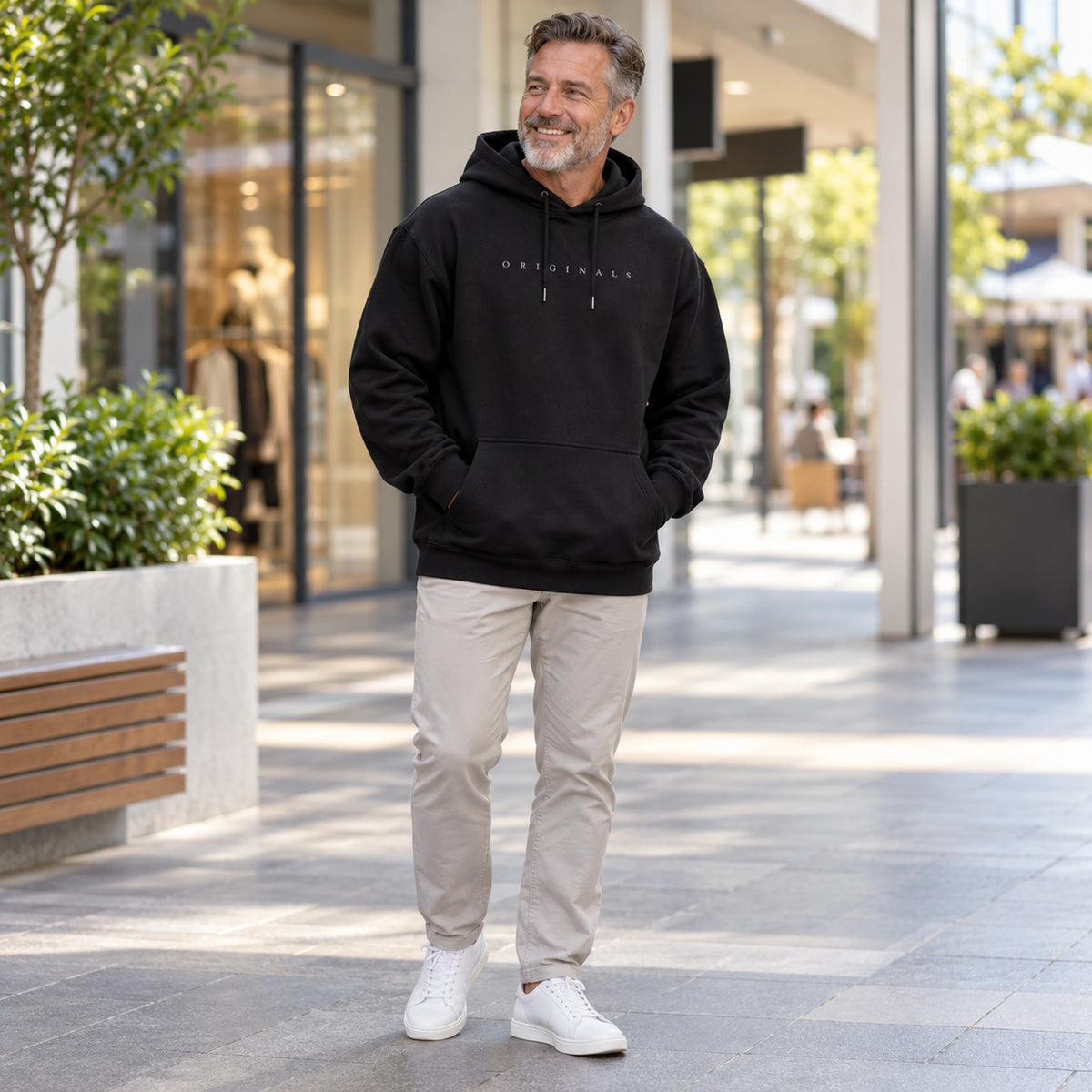 mens hoodie — Noah Black hoodie three quarter view on happy male model, complete garment — view 5