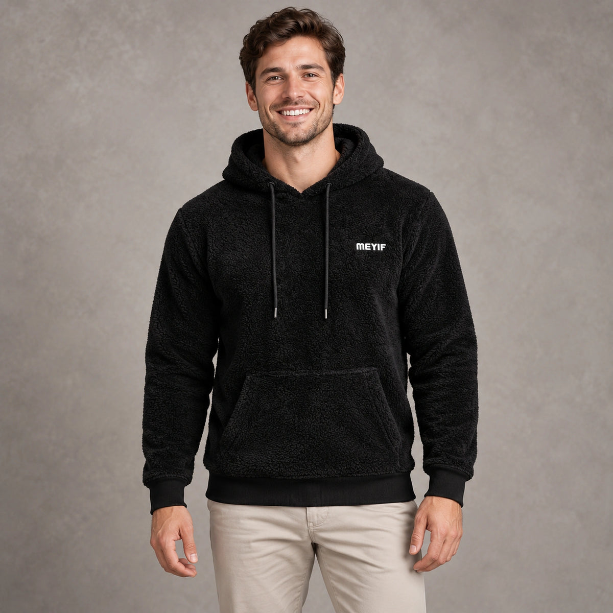 mens hoodie — Black Paul plush fleece pullover hoodie, complete front view on young model in warm neutral
