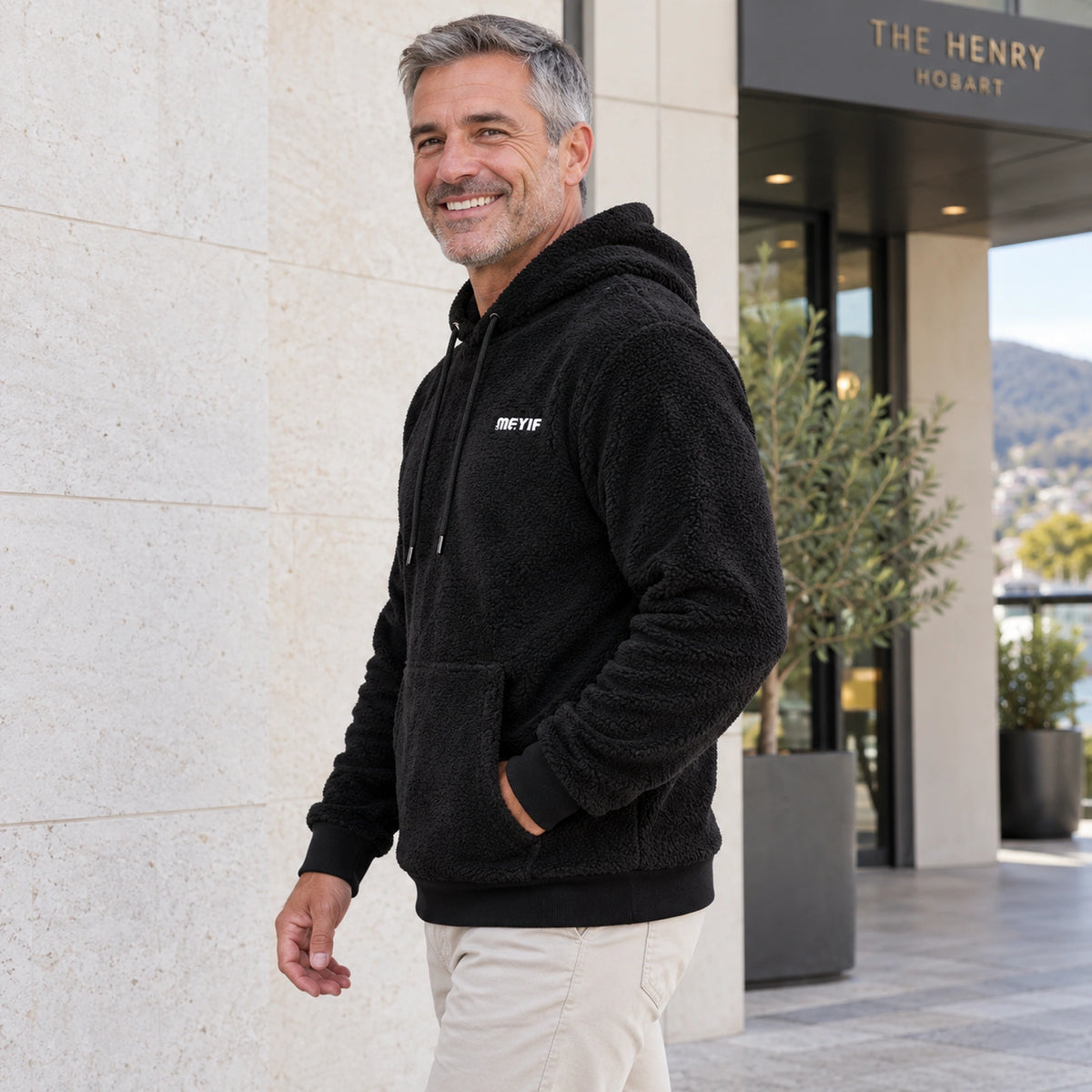 mens hoodie — Black Paul plush fleece pullover hoodie, full side profile on mature model — view 5