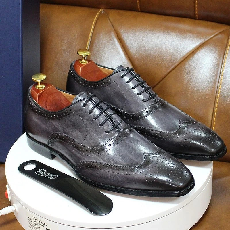 Elegant oxford loafers with brogue detailing and lace up design on a display stand — view 3 — view 4