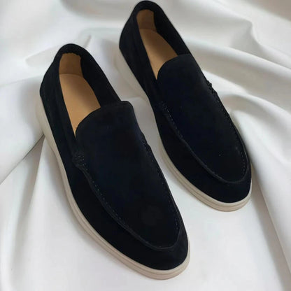 Black oxford loafers with sleek design and white soles on a draped fabric background — view 2 — view 3