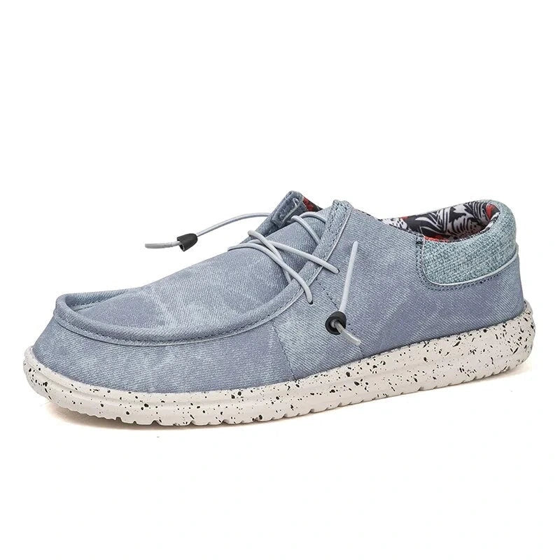 Light blue oxford loafers with a speckled sole and lace detail, side view — view 2