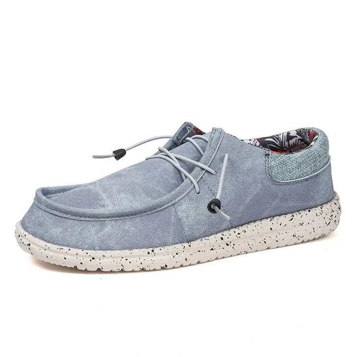 Light blue oxford loafers with a speckled sole and lace detail, side view — view 2