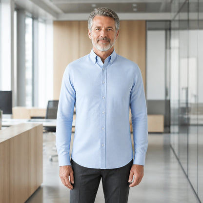Mature man wearing Blue smart casual long sleeve Oxford shirt, full front view with button down collar, cuffs, and — view 2