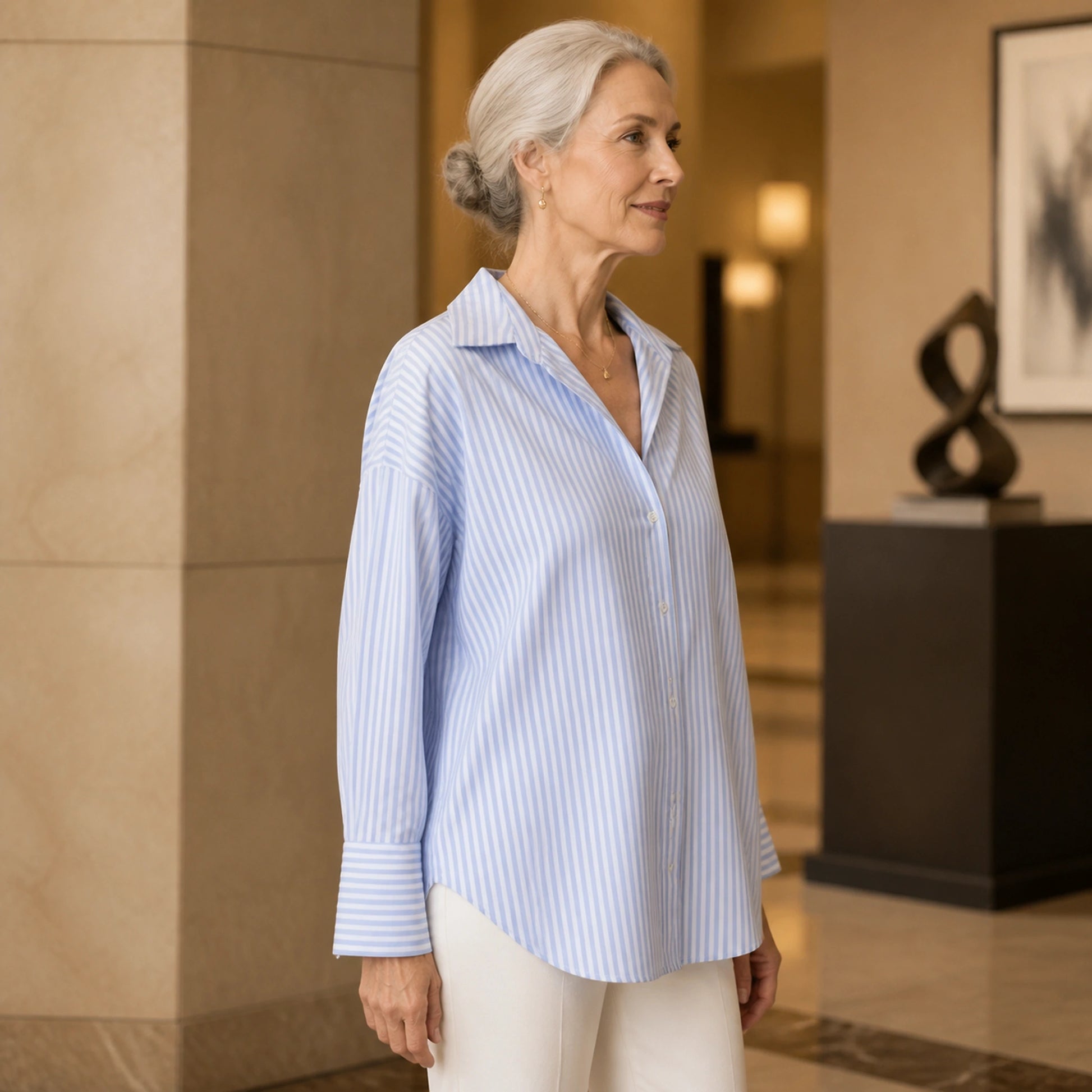 oxford shirt — Professional mature woman wearing the exact oversized Oxford blouse — view 4