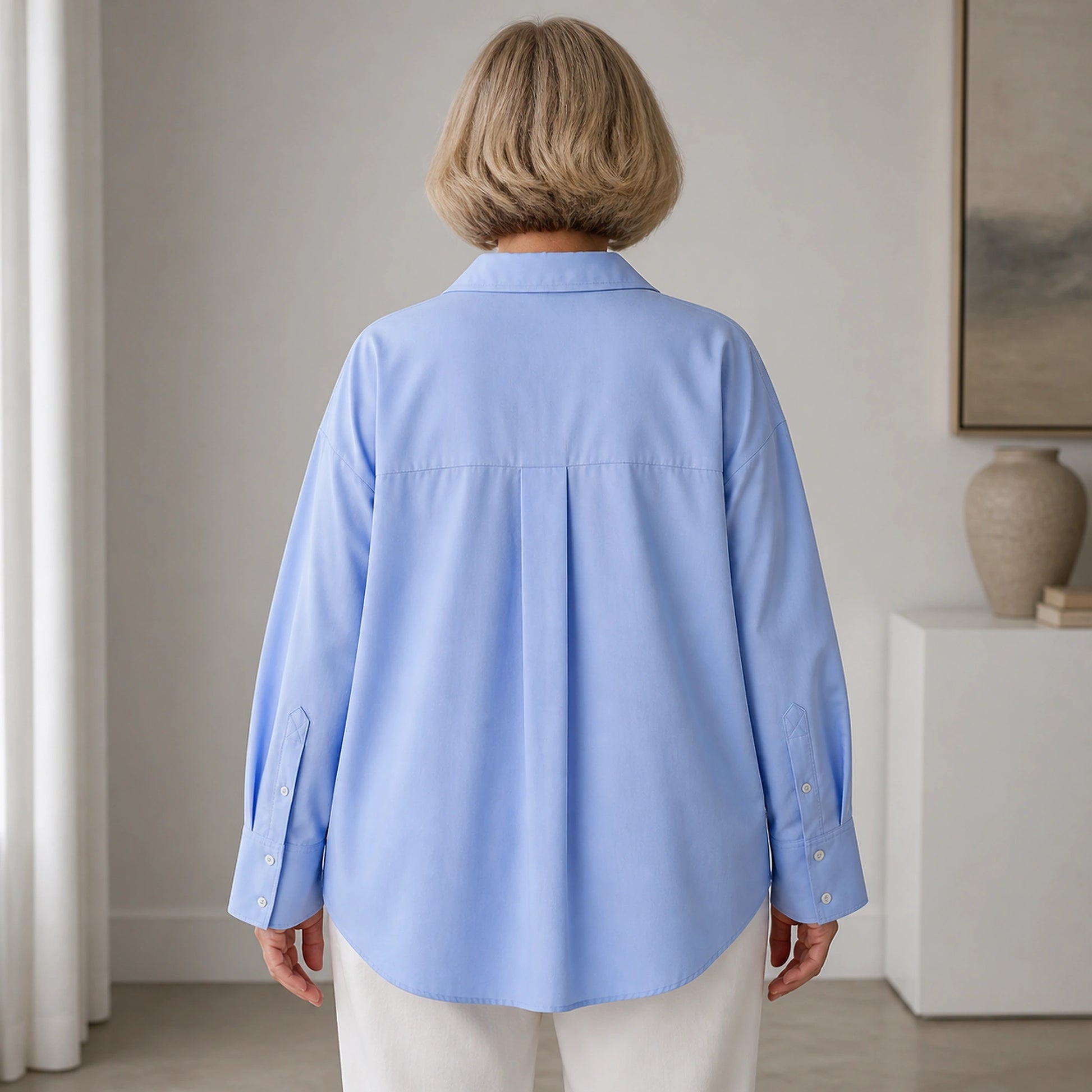 oxford shirt — Professional mature woman wearing the exact oversized Oxford blouse — view 5