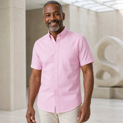 Mature man wearing the pink short sleeved Oxford shirt, complete collar to hem front view in a gallery setting — view 3
