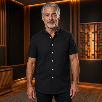 Mature man wearing the black short sleeved Oxford shirt, complete collar to hem front view in a warm — view 4